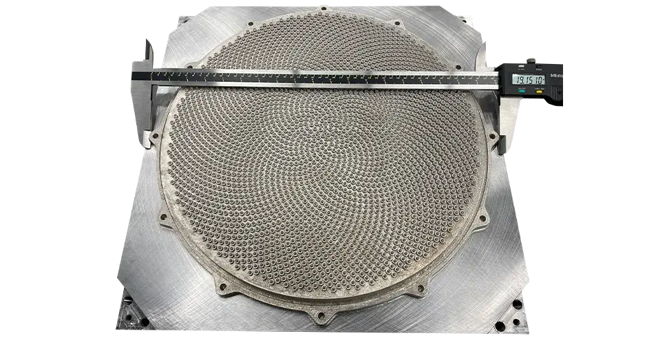 Una ducha impresa en 3D con una regla encima que da cuenta de sus dimensiones