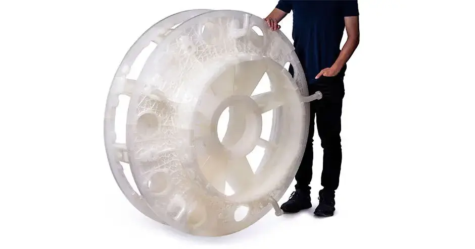 a person standing next to a 3D printed combustion casting